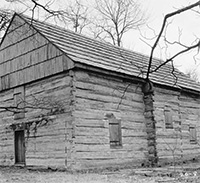 black and white photo of log cabin